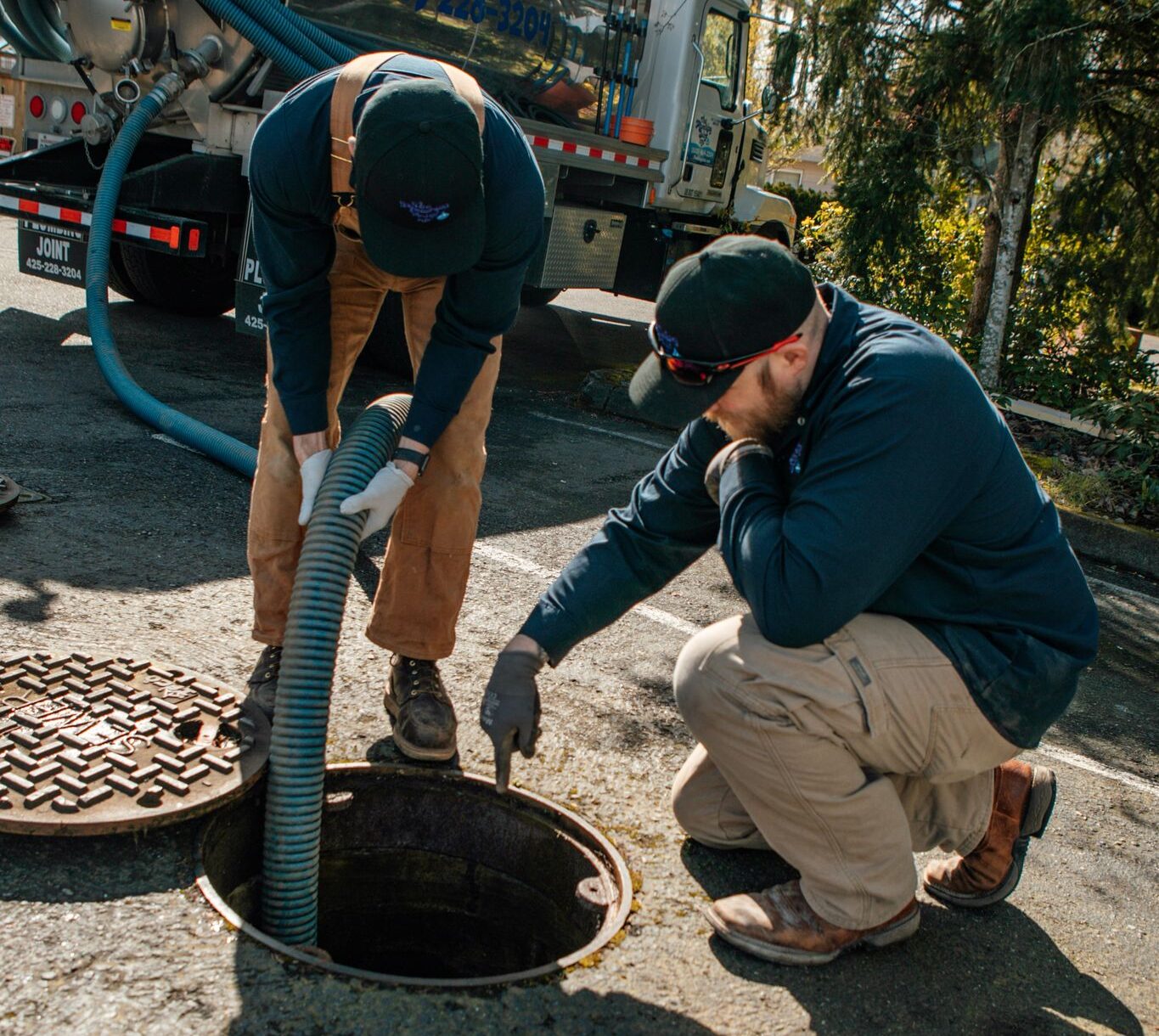 Plumbing Joint plumbers pumping with their truck